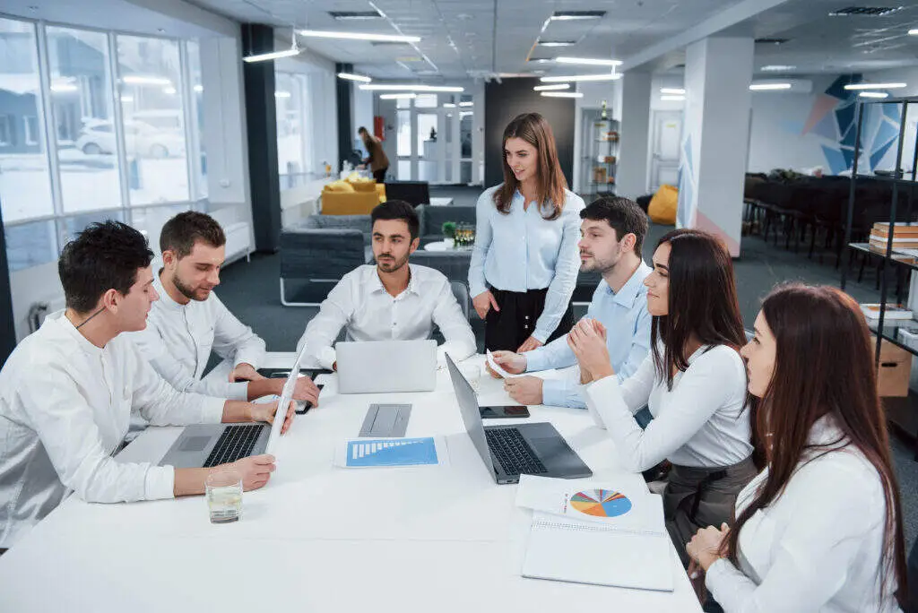 Man talking to colleagues in a coworking space